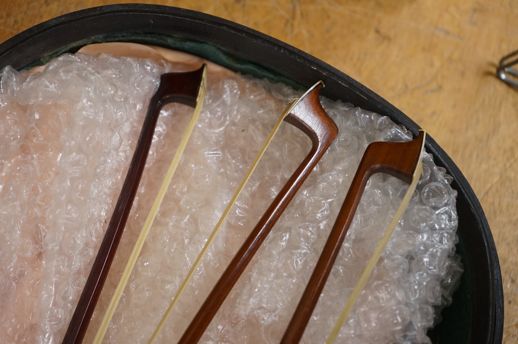 Three German violin bows; an octagonal stick stamped Penzal, together with another stamped E.L. Herrmann and a further unsigned example, all octagonal sticks and fully mounted with nickel mounts, together with an early 2